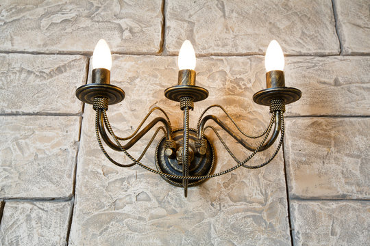 Brick wall chandelier in style of candlestick