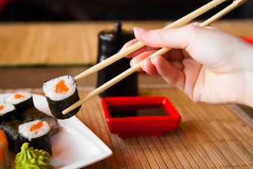 sushi keep chopsticks and dipped into the sauce