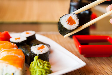 sushi keep chopsticks and dipped into the sauce