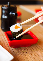 sushi keep chopsticks and dipped into the sauce