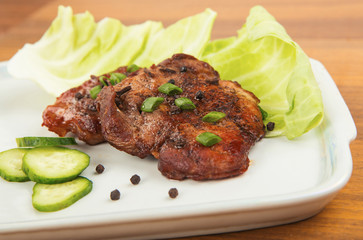 tasty grill meat with sauce and green on white plate