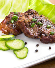 tasty grill meat with sauce and green on white plate