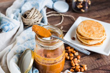 Obraz na płótnie Canvas peanut butter in a jar, eat a teaspoon and pancakes