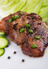 tasty grill meat with sauce and green on white plate