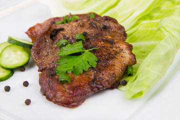 tasty grill meat with sauce and green on white plate