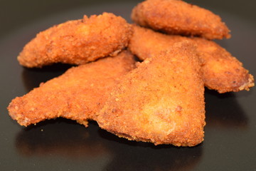 Plate of chicken nuggets with dip sauce.