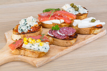 Tapas with cheese, salami and salmon