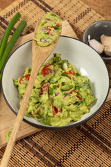 Guacamole with green onions. Selective focus.