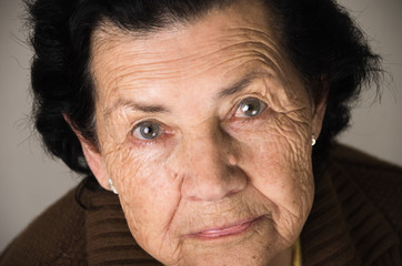 portrait of grandmother looking nostalgic at camera