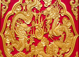 Golden dragon decorated on red wall