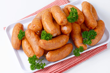 Pile of Polish sausages on plate