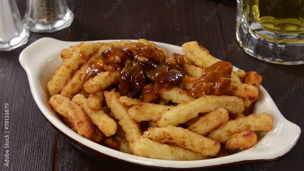 Canvas Prints spooning chili onto french fries