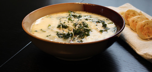 Zuppa toscana soup with sliced baguette