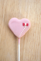 Pink strawberry candy on a stick in the form of heart