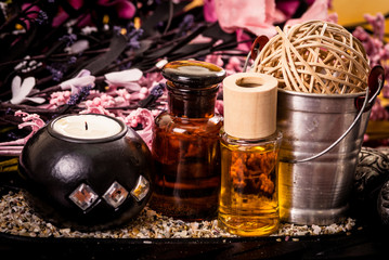 candle and oils with pink flowers spa concept