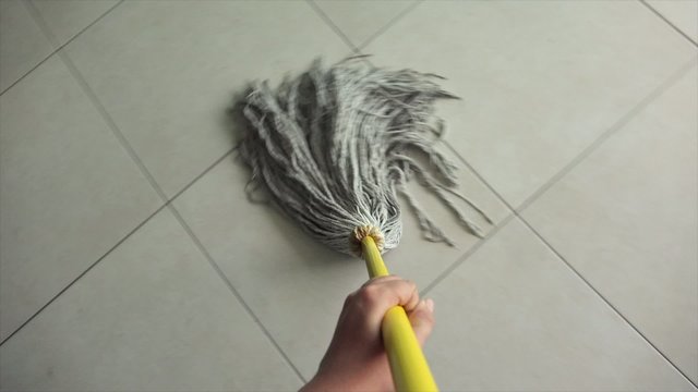 Woman Doing Chores Washing Floor At Home