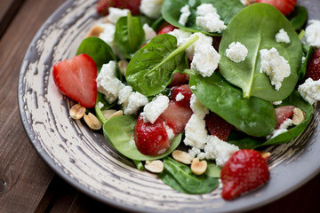 Close-up of spinach, strawberry and cheese salad
