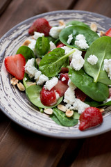 Salad with spinach, strawberry and cheese, selective focus