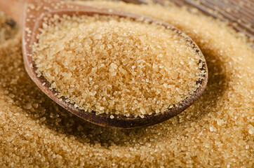 Raw Organic Cane Sugar in  wooden spoon