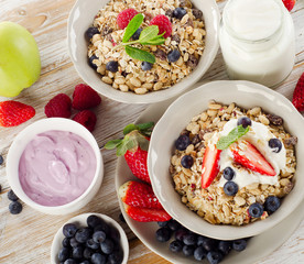 Muesli,  fresh berries and yogurt for  breakfast  on  wooden tab