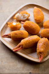 Close-up of breaded crab claws on a bamboo tray, selective focus