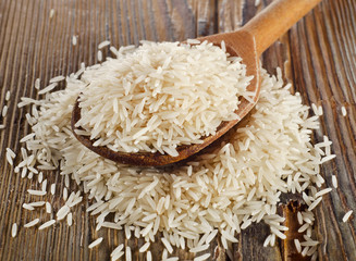 Raw basmati rice in  wooden  spoon