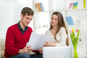 View of an Attractive couple doing administrative paperwork. 