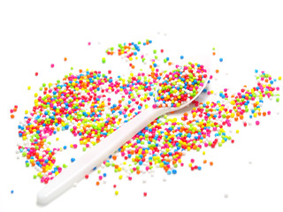 colorful sugar pearls in white spoon
