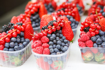 basket with fresh juicy berries on farmer market