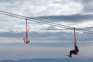 Skiers on chairlift in moutain