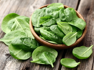 Spinach on a wooden background