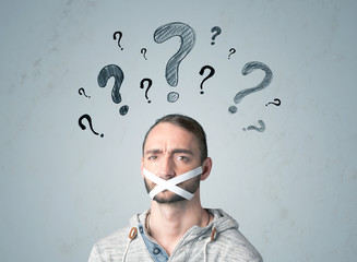 Young man with glued mouth and question mark symbols
