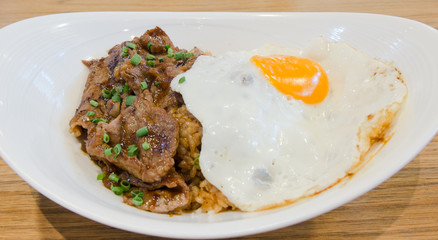 Rice with roast beef  barbecue sauce and fried egg