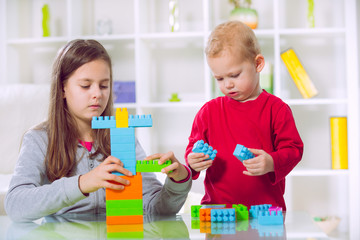 Two children play with blocks