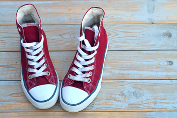 red canvas sneakers on a old wooden background