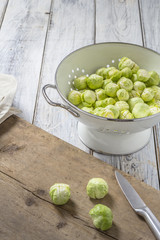 Brussels sprouts in a sieve on a table