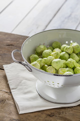 Brussels sprouts in a sieve on a table