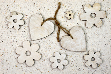 Obraz na płótnie Canvas wooden hearts as photoframe at hand made paper background