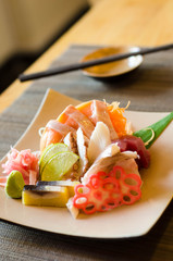 A colorful platter of sashimi sushi