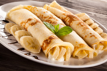 Pancakes with cream and bananas