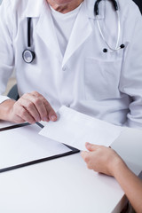 Doctor accpeting an envelope