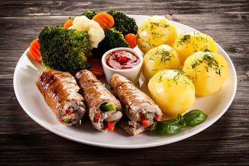 Wrapped pork chop, boiled potatoes and vegetables