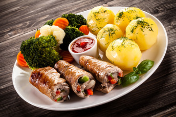 Wrapped pork chop, boiled potatoes and vegetables