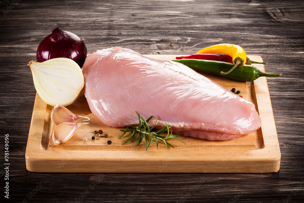 Wall mural raw turkey fillet on cutting board