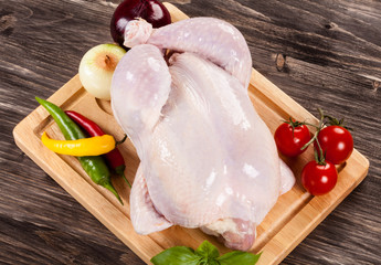Raw chicken on cutting board
