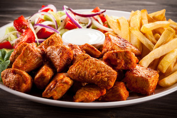 Fried chicken nuggets, French fries and vegetables