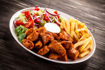 Fried chicken nuggets, French fries and vegetables