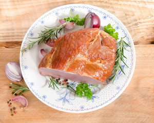 raw roast pork on a plate from above