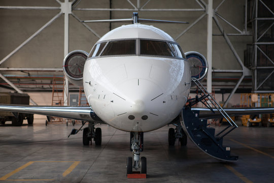 Business jet airplane stays in hangar.