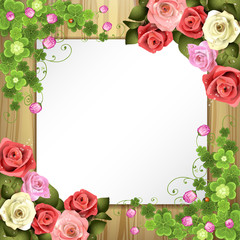 Wood background with sheet of paper, clover and roses